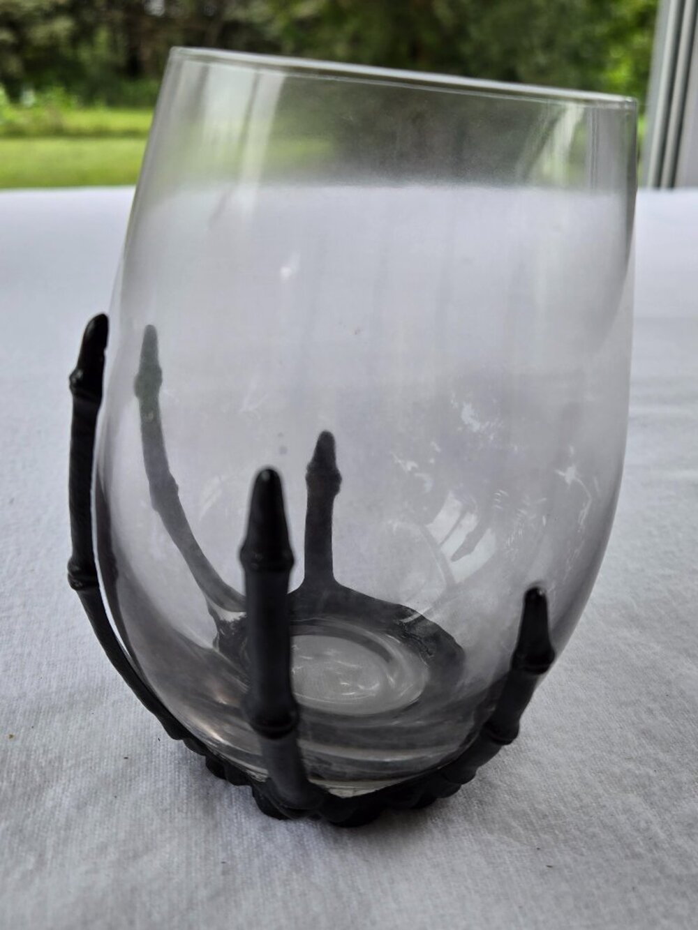 Stemless wine glass with black skeleton hand